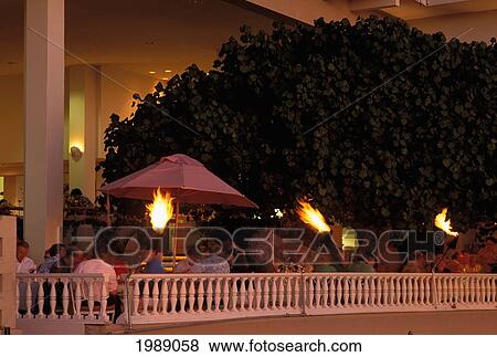 Hawaii, Oahu, Waikiki, Kaimana Beach Hotel Restaurant, Outdoor Cocktails At Sunset. View Large Photo Image Stock Photo - Hawaii, Oahu, Waikiki, Kaimana Beach Hotel Restaurant, Outdoor Cocktails At Sunset.. Fotosearch