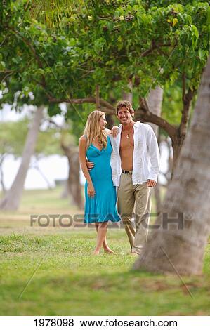 Hawaii, Oahu, Waikiki, Kapiolani Park, Couple Walking In A Tropical Setting. View Large Photo Image Stock Photo - Hawaii, Oahu, Waikiki, Kapiolani Park, Couple Walking In A Tropical Setting.. Fotosearch