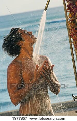 Stock Photo - Hawaii, Oahu, Waikiki, Local Man Stands Under Outdoor Shower.. Fotosearch