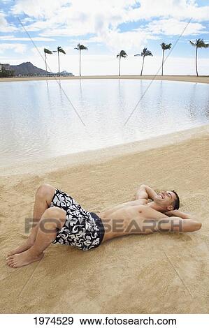 Hawaii, Oahu, Waikiki, Male Excercising On The Beach. View Large Photo Image Stock Photo - Hawaii, Oahu, Waikiki, Male Excercising On The Beach.. Fotosearch