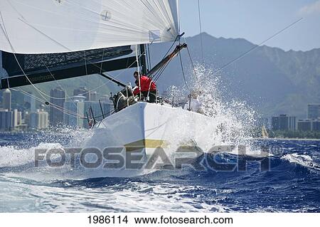 Hawaii, Oahu, Waikiki Offshore Series 2005, Sailboat On Blue Ocean, Land In Background. View Large Photo Image Picture - Hawaii, Oahu, Waikiki Offshore Series 2005, Sailboat On Blue Ocean, Land In Background.. Fotosearch