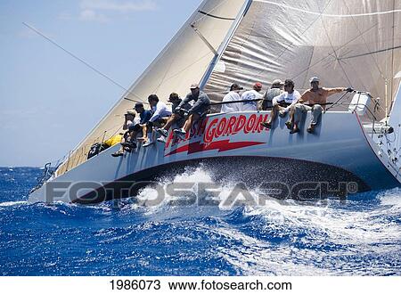 Stock Image - Hawaii, Oahu, Waikiki Offshore Series 2005, Sailboat On Blue Ocean.. Fotosearch