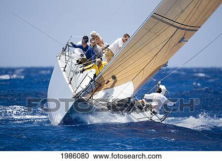 Stock Image - Hawaii, Oahu, Waikiki Offshore Series 2005, Sailboat On Blue Ocean.. Fotosearch