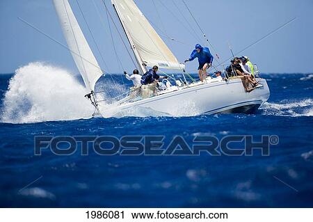 Stock Image - Hawaii, Oahu, Waikiki Offshore Series 2005, Sailboat On Blue Ocean.. Fotosearch