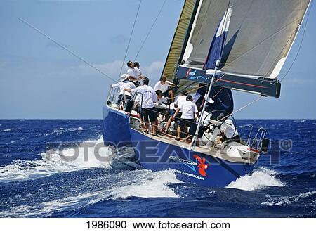 Stock Image - Hawaii, Oahu, Waikiki Offshore Series 2005, Sailboat On Blue Ocean.. Fotosearch