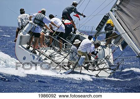 Stock Image - Hawaii, Oahu, Waikiki Offshore Series 2005, Sailboat On Blue Ocean.. Fotosearch