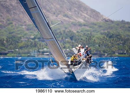 Hawaii, Oahu, Waikiki Offshore Series 2005, Sailboat On Blue Ocean, Land In Background. View Large Photo Image Stock Image - Hawaii, Oahu, Waikiki Offshore Series 2005, Sailboat On Blue Ocean, Land In Background.. Fotosearch