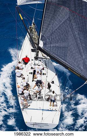 Stock Image - Hawaii, Oahu, Waikiki Offshore Series 2005, Sailboat On Blue Ocean.. Fotosearch