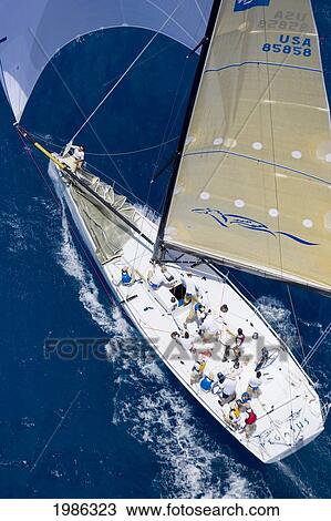 Stock Image - Hawaii, Oahu, Waikiki Offshore Series 2005, Sailboat On Blue Ocean.. Fotosearch