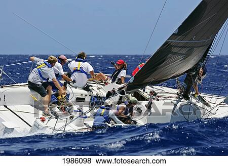 Stock Photo - Hawaii, Oahu, Waikiki Offshore Series 2005, Sailboat On Blue Ocean.. Fotosearch