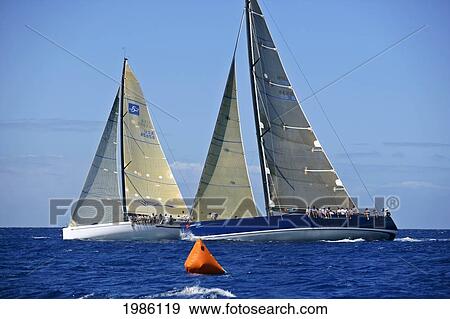 Stock Photo - Hawaii, Oahu, Waikiki Offshore Series 2005, Sailboat On Blue Ocean, Two Boats Side By Side.. Fotosearch