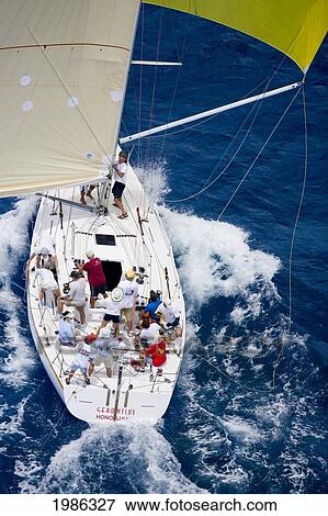 Stock Photo - Hawaii, Oahu, Waikiki Offshore Series 2005, Sailboat On Blue Ocean.. Fotosearch