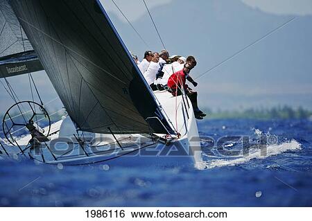 Stock Photograph - Hawaii, Oahu, Waikiki Offshore Series 2005, Sailboat On Blue Ocean, Land In Background.. Fotosearch