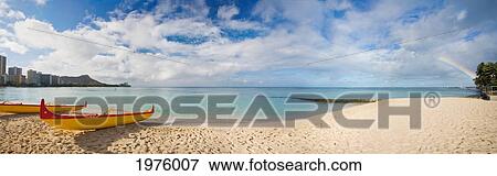 Stock Photo - Hawaii, Oahu, Waikiki, Outrigger Canoes On The Beach With A Rainbow And Diamond Head In The Background.. Fotosearch