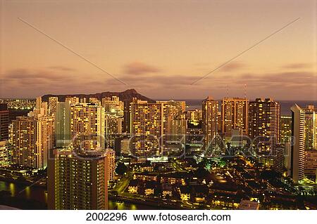 Stock Photograph - Hawaii, Oahu, Waikiki, Skyline At Twilight, Pink Clouds And Golden Hues, Diamond Head Background. Fotosearch