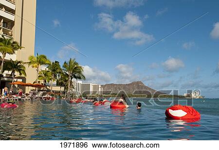 Hawaii, Oahu, Waikiki, Visitors Play And Float At The Sheraton Hotel Pool. View Large Photo Image Stock Photograph - Hawaii, Oahu, Waikiki, Visitors Play And Float At The Sheraton Hotel Pool.. Fotosearch
