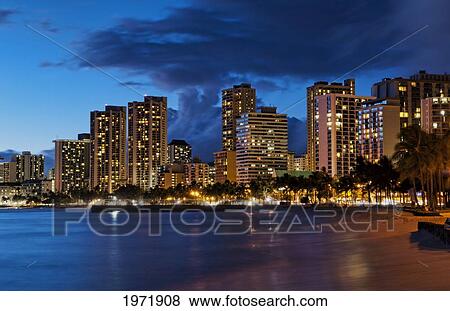 Stock Photo - Hawaii, Oahu, Waikiki, Waikiki Beach At Night With Veiw Of City Lights And Buildings.. Fotosearch
