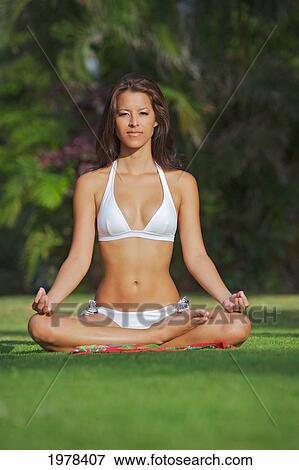 Stock Photo - Hawaii, Oahu, Waikiki, Woman Doing Yoga On Grass At Kapiolani Park.. Fotosearch