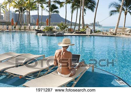 Hawaii, Oahu, Waikiki, Woman Lounging At Hotel Poolside With Laptop Computer, Diamond Head In Distance. View Large Photo Image Stock Photo - Hawaii, Oahu, Waikiki, Woman Lounging At Hotel Poolside With Laptop Computer, Diamond Head In Distance.. Fotosearch