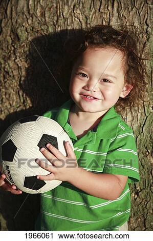 Hawaii, Oahu, Waikiki, Young Boy Poses For Camera With His Soccerball. View Large Photo Image Stock Image - Hawaii, Oahu, Waikiki, Young Boy Poses For Camera With His Soccerball.. Fotosearch