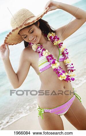 Hawaii, Oahu, Waikiki, Young Woman Modeling Hat At Beach. View Large Photo Image Picture - Hawaii, Oahu, Waikiki, Young Woman Modeling Hat At Beach.. Fotosearch