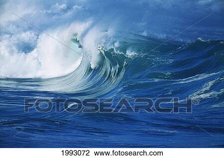 Stock Image - Hawaii, Oahu, Waimea Shorebreak, Side View Large, Misty Wave Coming In To Shore.. Fotosearch