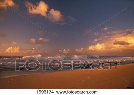 Hawaii, Oahu, Wave Crashes On North Shore Beach Sunset Sky With Fluffy Warm Clouds View Large Photo Image Picture - Hawaii, Oahu, Wave Crashes On North Shore Beach Sunset Sky With Fluffy Warm Clouds. Fotosearch