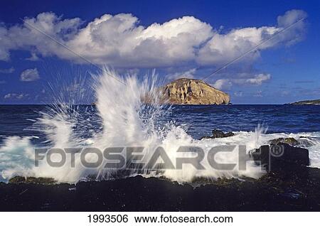 Hawaii, Oahu, Waves Breaking On Lava Rock Coast At Makapu'u With Rabbit Island In The Distance. View Large Photo Image Stock Photograph - Hawaii, Oahu, Waves Breaking On Lava Rock Coast At Makapu'u With Rabbit Island In The Distance.. Fotosearch