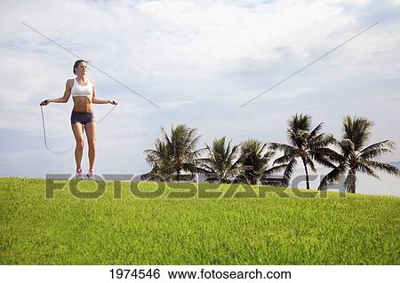 Hawaii, Oahu, Woman Excercising With Jump Rope. View Large Photo Image Stock Photograph - Hawaii, Oahu, Woman Excercising With Jump Rope.. Fotosearch