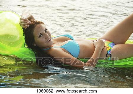 Hawaii, Oahu, Young Beautiful Female Relaxing On A Bright Beach Floater In The Water View Large Photo Image Stock Image - Hawaii, Oahu, Young Beautiful Female Relaxing On A Bright Beach Floater In The Water. Fotosearch