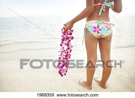 Hawaii, Oahu, Young Girl Holding An Orchid Lei, View From Behind. View Large Photo Image Stock Photo - Hawaii, Oahu, Young Girl Holding An Orchid Lei, View From Behind.. Fotosearch