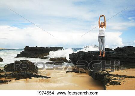 Picture - Hawaii, Oahu, Young Girl On The Beach Excercising.. Fotosearch
