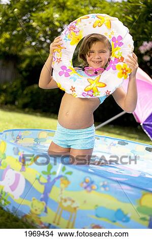 Hawaii, Oahu, Young Girl Playing In A Pool With An Innertube. View Large Photo Image Picture - Hawaii, Oahu, Young Girl Playing In A Pool With An Innertube.. Fotosearch