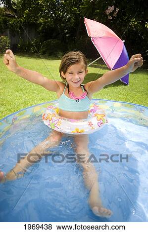 Hawaii, Oahu, Young Girl Playing In A Pool With An Innertube. View Large Photo Image Stock Photo - Hawaii, Oahu, Young Girl Playing In A Pool With An Innertube.. Fotosearch