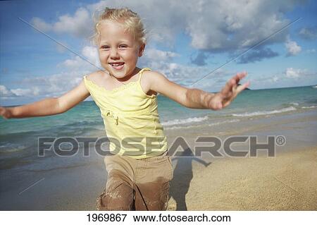 Stock Photo - Hawaii, Oahu, Young Girl Running On The Beach.. Fotosearch
