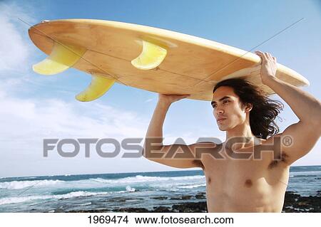 Picture - Hawaii, Oahu, Young Man At The Beach With Surfboard.. Fotosearch