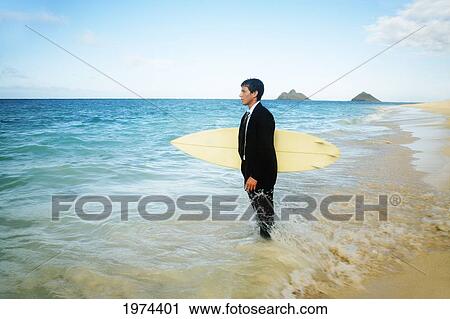 Hawaii, Oahu, Young Man At The Beach With Surfboard In Business Attire. View Large Photo Image Stock Image - Hawaii, Oahu, Young Man At The Beach With Surfboard In Business Attire.. Fotosearch