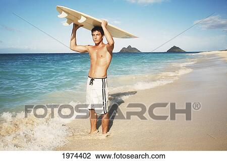Hawaii, Oahu, Young Man At The Beach With Surfboard. View Large Photo Image Stock Image - Hawaii, Oahu, Young Man At The Beach With Surfboard.. Fotosearch
