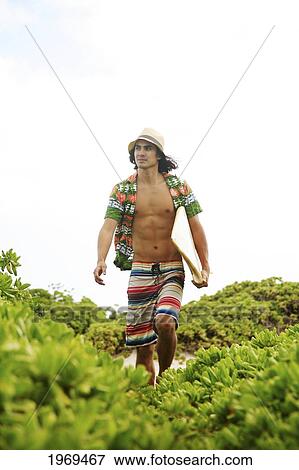 Stock Photo - Hawaii, Oahu, Young Man At The Beach With Surfboard.. Fotosearch