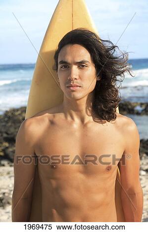 Stock Photography - Hawaii, Oahu, Young Man At The Beach With Surfboard.. Fotosearch