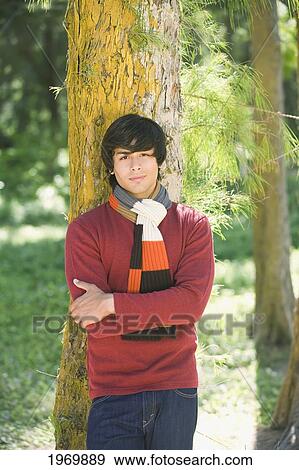 Stock Photo - Hawaii, Oahu, Young Man Dressed In Warm Winter Clothes.. Fotosearch