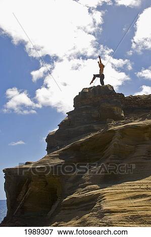 Stock Photo - Hawaii, Oahu, Young Woman Doing Yoga On A Cliff Next To The Ocean.. Fotosearch