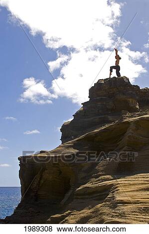 Hawaii, Oahu, Young Woman Doing Yoga On A Cliff Next To The Ocean. View Large Photo Image Stock Photo - Hawaii, Oahu, Young Woman Doing Yoga On A Cliff Next To The Ocean.. Fotosearch