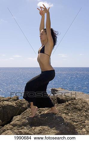Picture - Hawaii, Oahu, Young Woman Doing Yoga Next To The Ocean.. Fotosearch