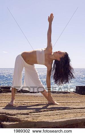 Hawaii, Oahu, Young Woman Doing Yoga Next To The Ocean. View Large Photo Image Stock Image - Hawaii, Oahu, Young Woman Doing Yoga Next To The Ocean.. Fotosearch