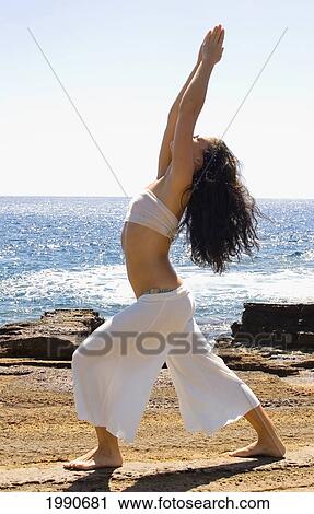 Hawaii, Oahu, Young Woman Doing Yoga Next To The Ocean. View Large Photo Image Stock Image - Hawaii, Oahu, Young Woman Doing Yoga Next To The Ocean.. Fotosearch