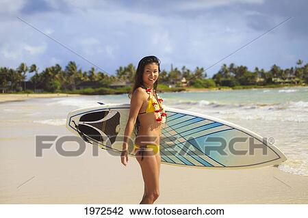 Hawaii, Oahu, Young Woman Poses With Her Surfboard, About To Enter Water. View Large Photo Image Stock Image - Hawaii, Oahu, Young Woman Poses With Her Surfboard, About To Enter Water.. Fotosearch