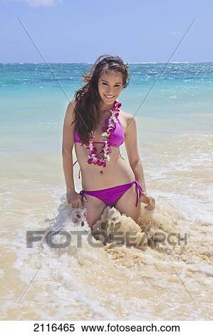 Hawaii, Oahu, Young woman posing in ocean, Sun shining. View Large Photo Image Stock Photography - Hawaii, Oahu, Young woman posing in ocean, Sun shining.. Fotosearch