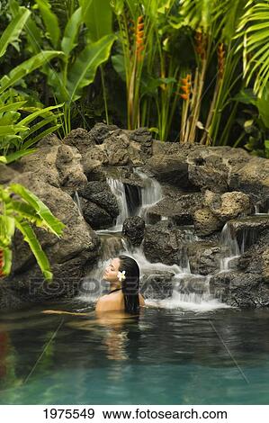 Stock Photo - Hawaii, Oahu, Young Woman Relaxing In Tropical Pool.. Fotosearch