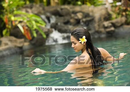 Stock Photo - Hawaii, Oahu, Young Woman Relaxing In Tropical Pool.. Fotosearch